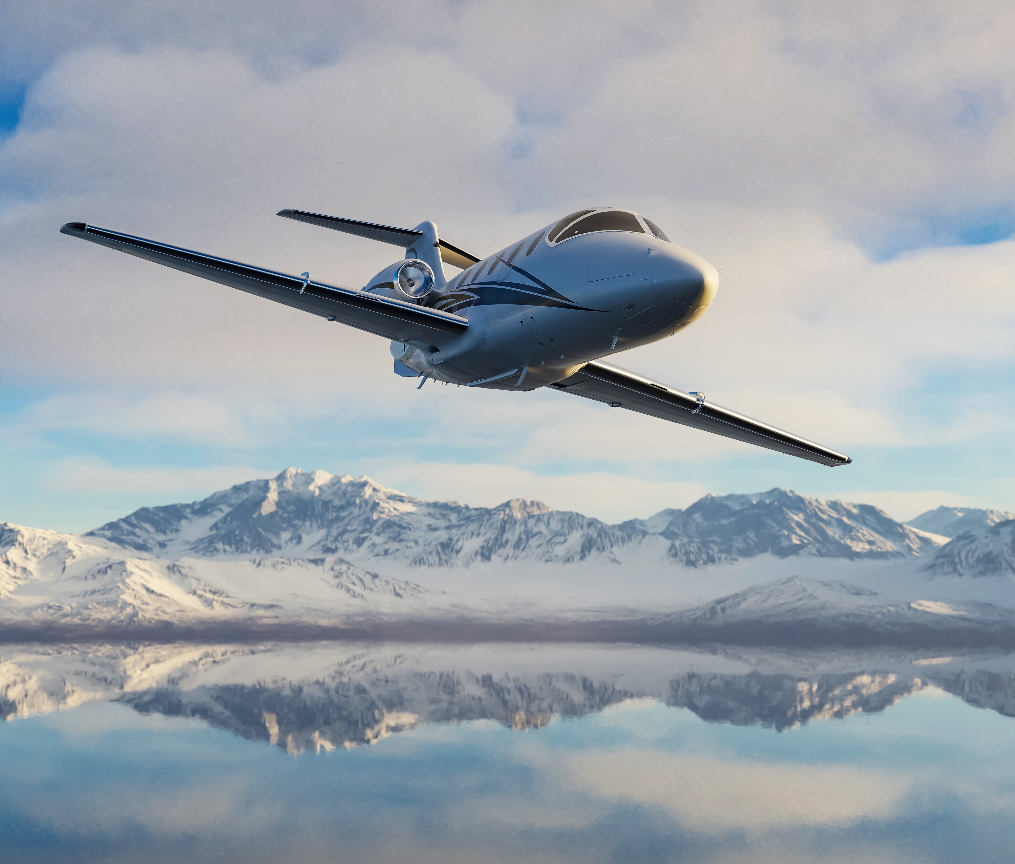 Business jet front view against snow-covered alpine mountains
